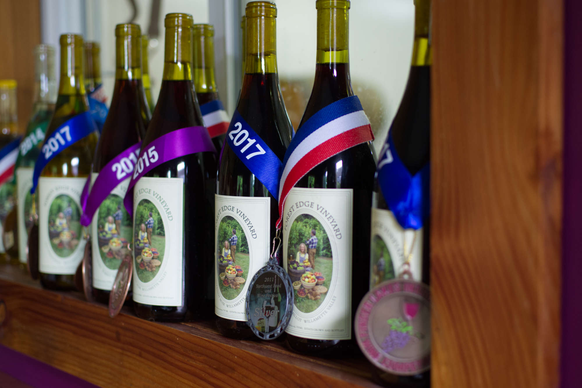 Bottles of wine with medals for wine competitions around them
